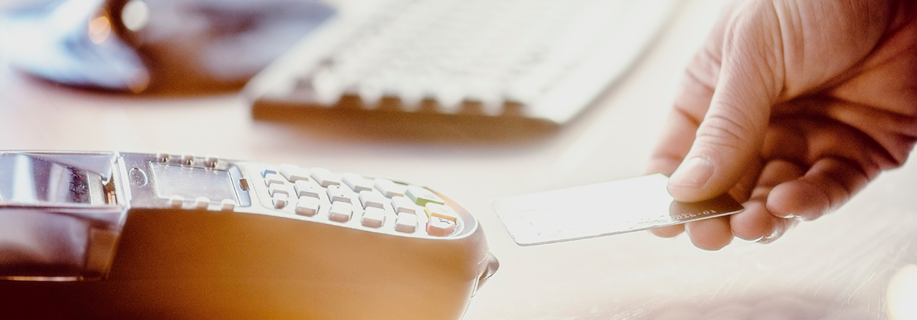 hand inserting card into chip reader