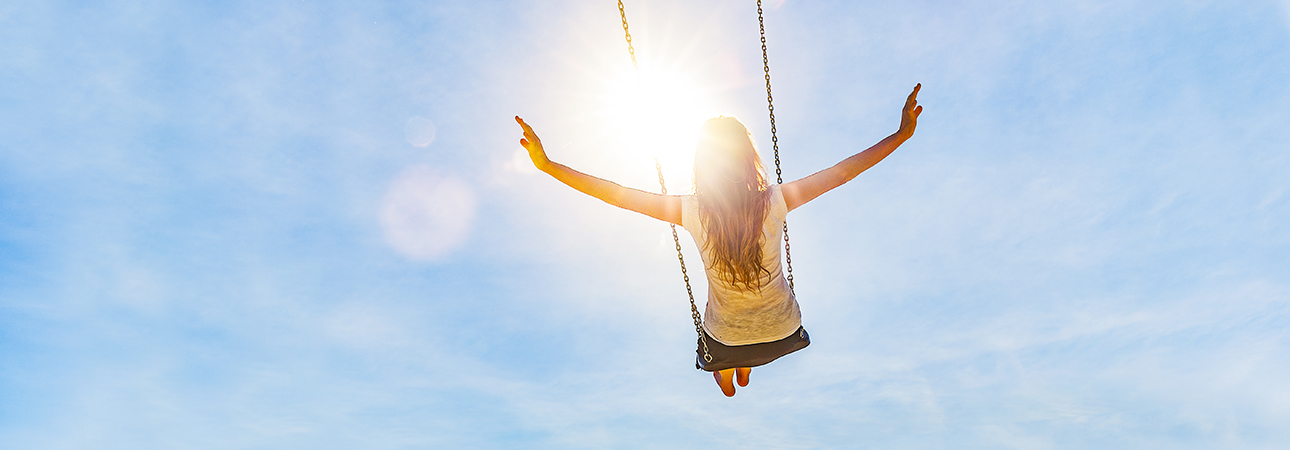 Woman on swing moving skyward