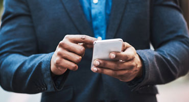 Man's hands using smartphone