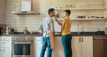 Couple cooking dinner in newly renovated kitchen