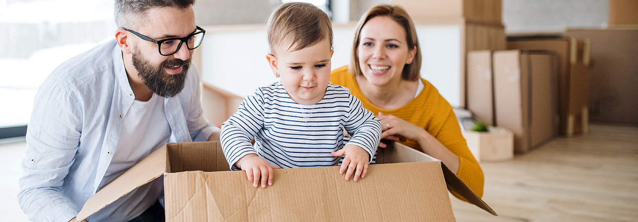 family unpacking boxes at new home